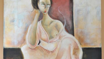 A painting of a seated figure with a contemplative expression, set against a backdrop of vertical panels.