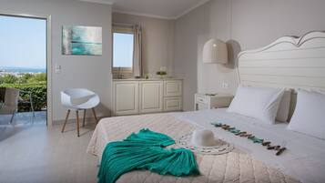 A bedroom with a bed, a chair, a desk, and a view of the outdoors.