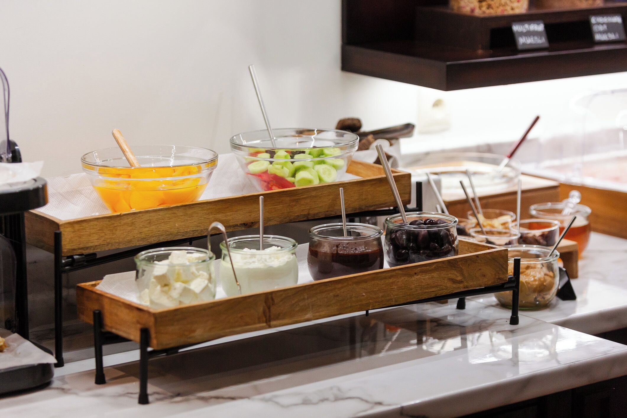 A buffet setup with various food items and condiments.