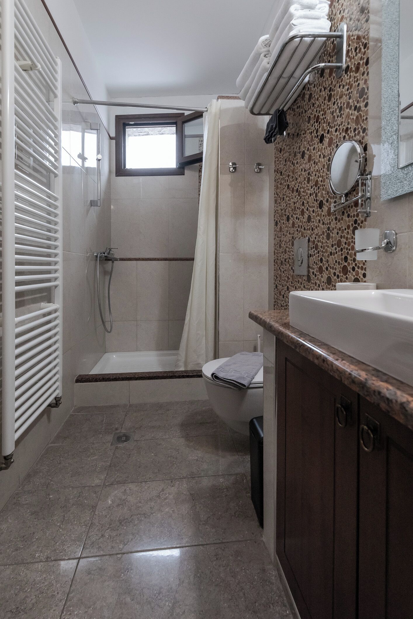 A bathroom with a shower, toilet, and sink.