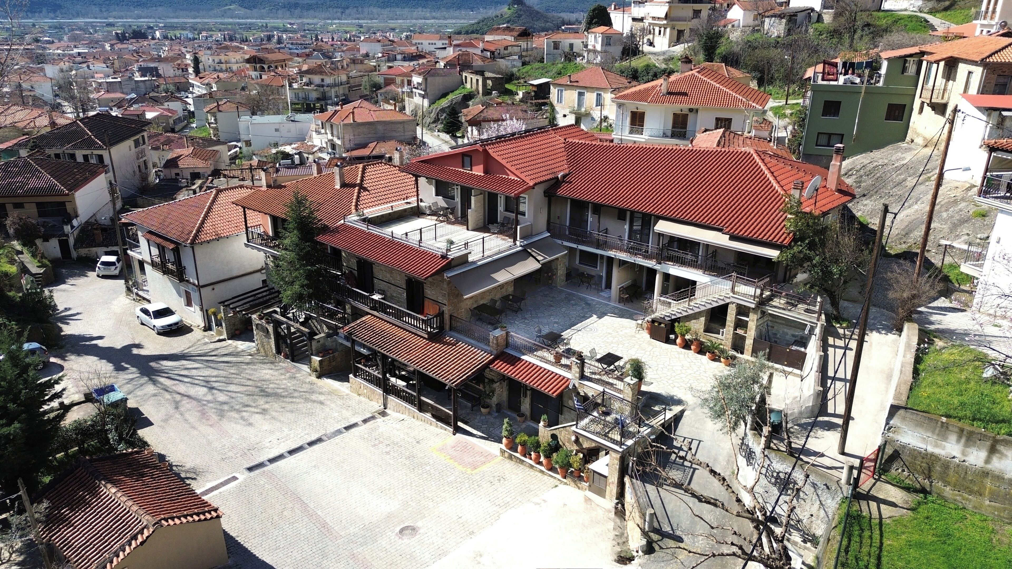 A residential building with multiple balconies, a courtyard, and a view of the surrounding neighborhood.