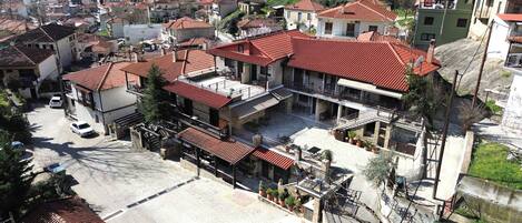 A residential building with multiple balconies, a courtyard, and a view of the surrounding neighborhood.