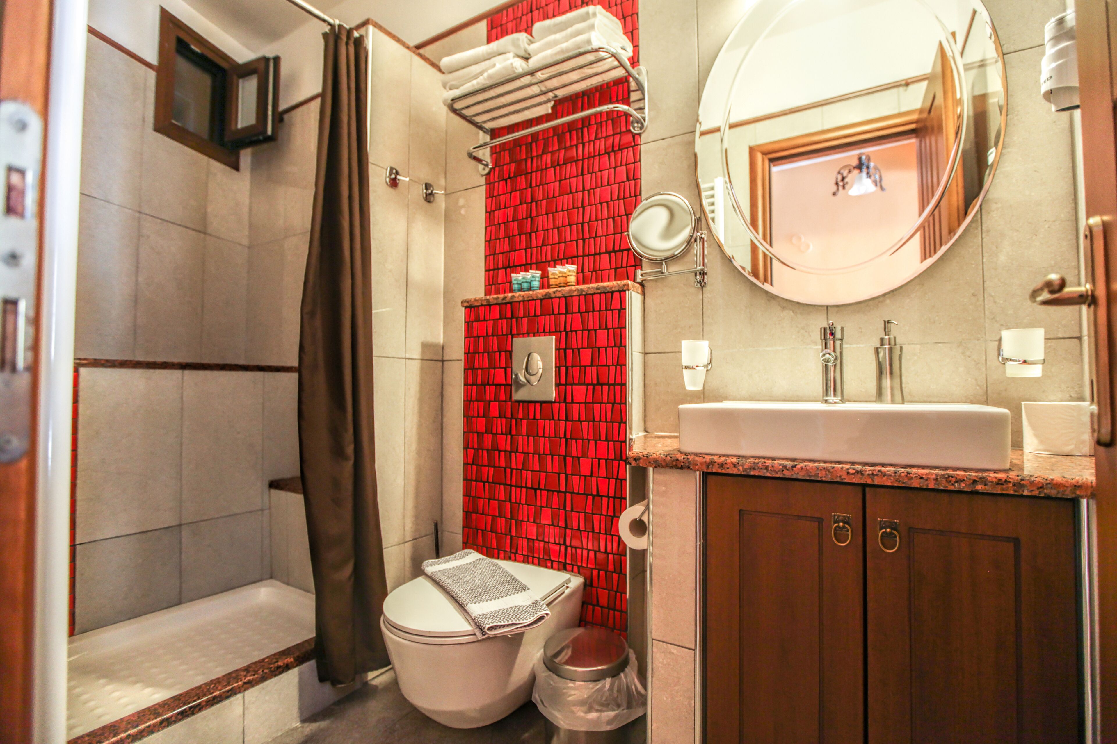 Een badkamer met douche, toilet en wastafel.