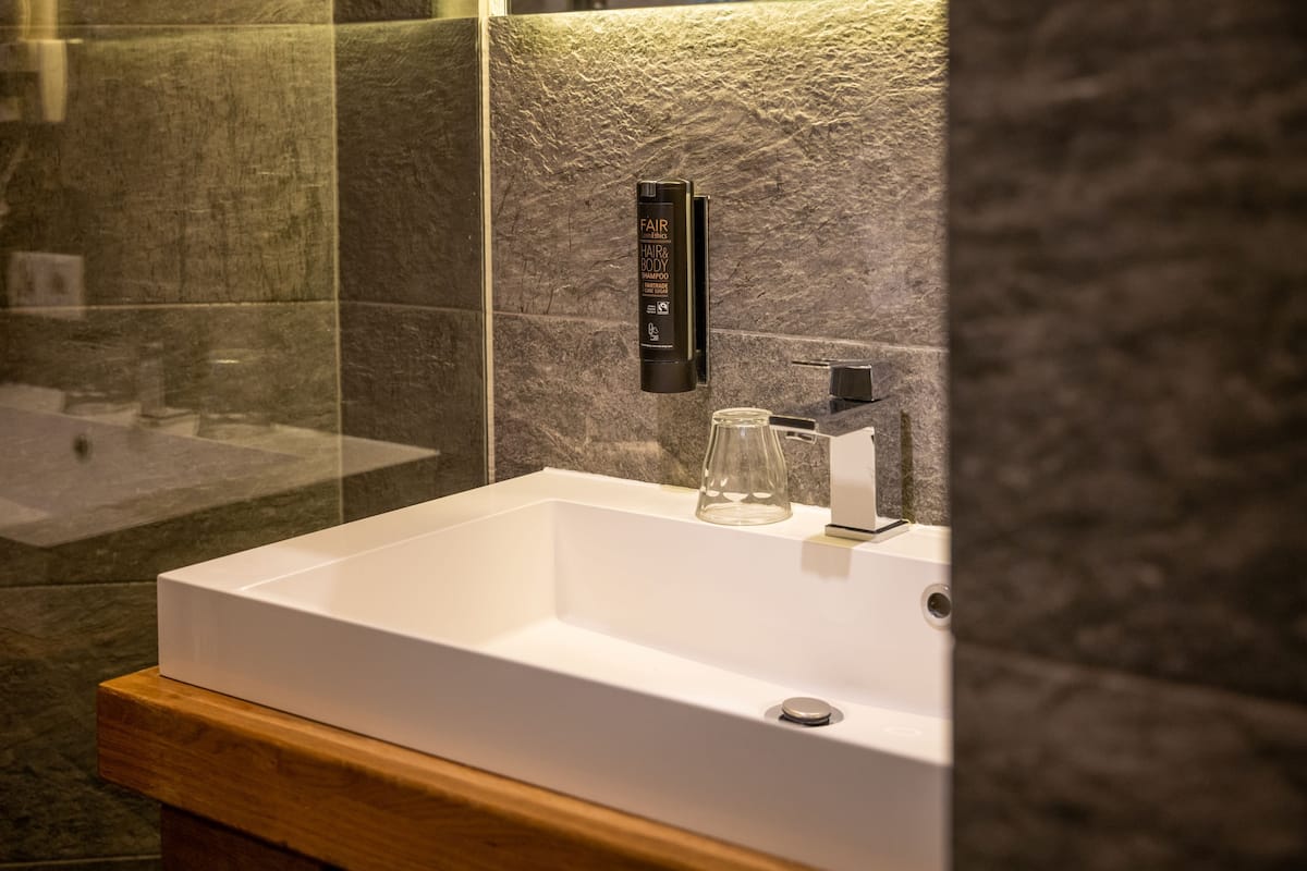 luxury apartment (family) | bathroom | free toiletries, hair dryer, dressing gowns, slippers