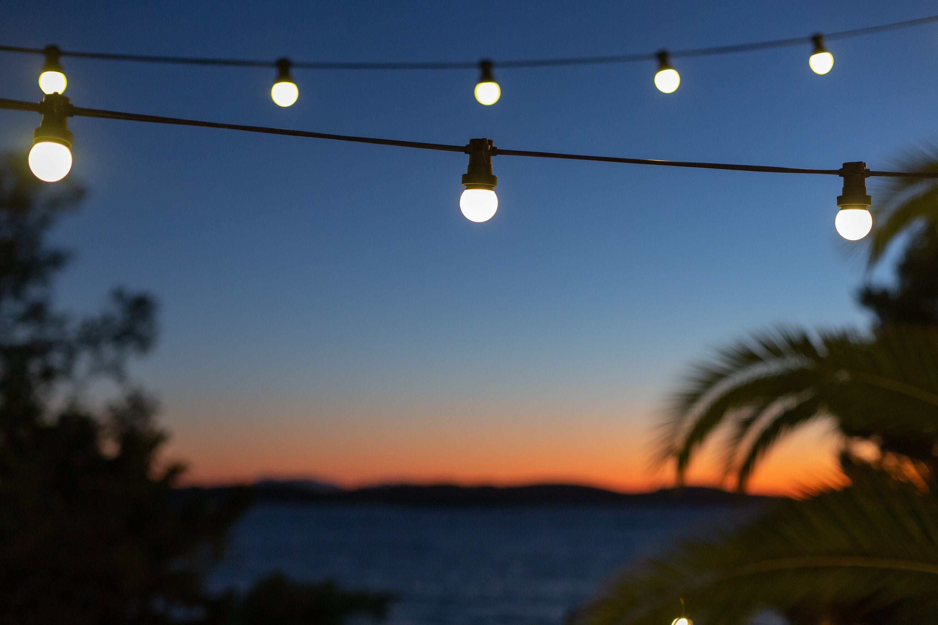 A string of lights against a twilight sky.