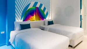A modern hotel room with two beds, a large abstract wall art piece, and a blue accent wall. - Budacco (Bangkok)