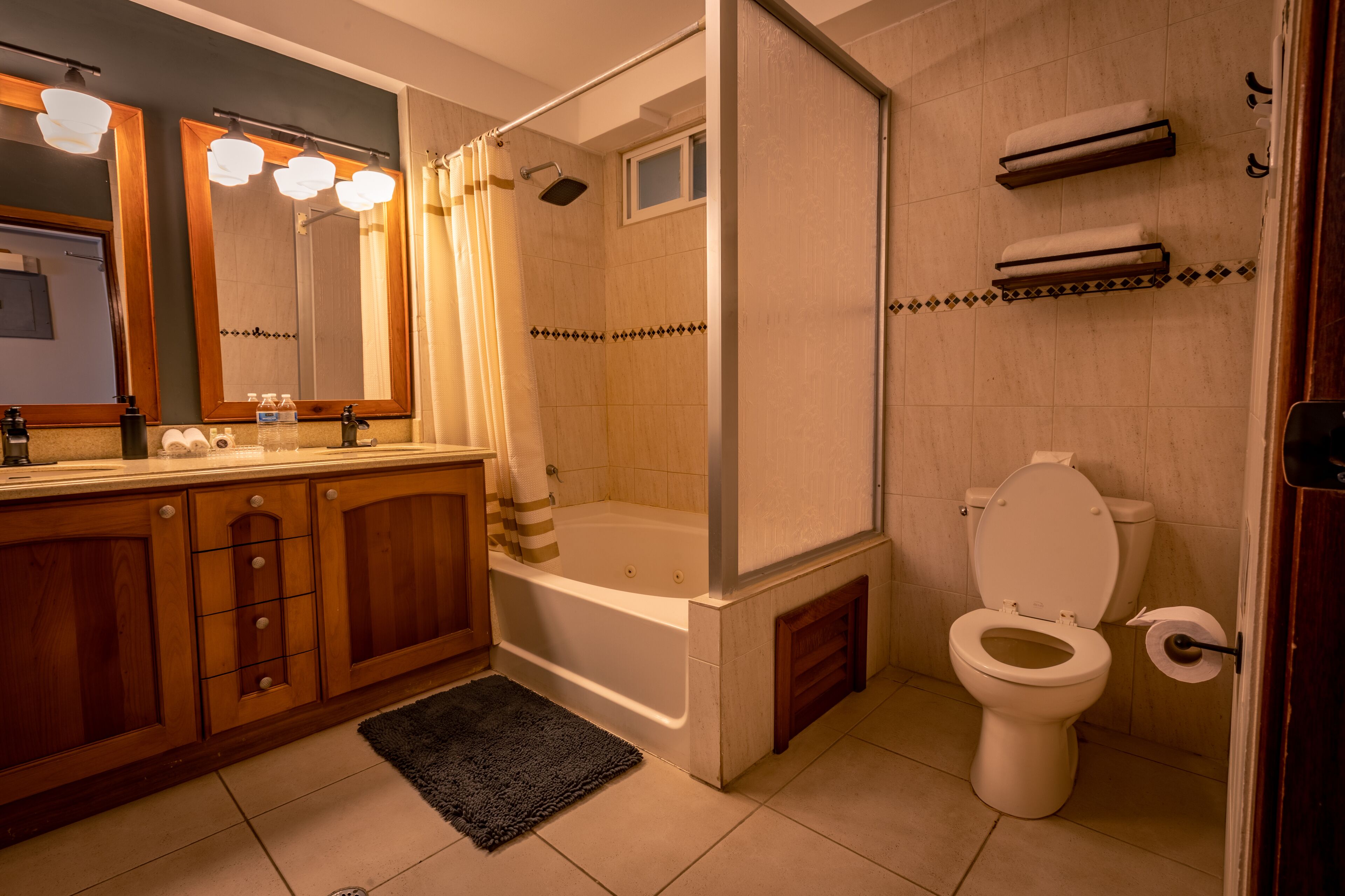 A bathroom with a bathtub, toilet, and a shower area.