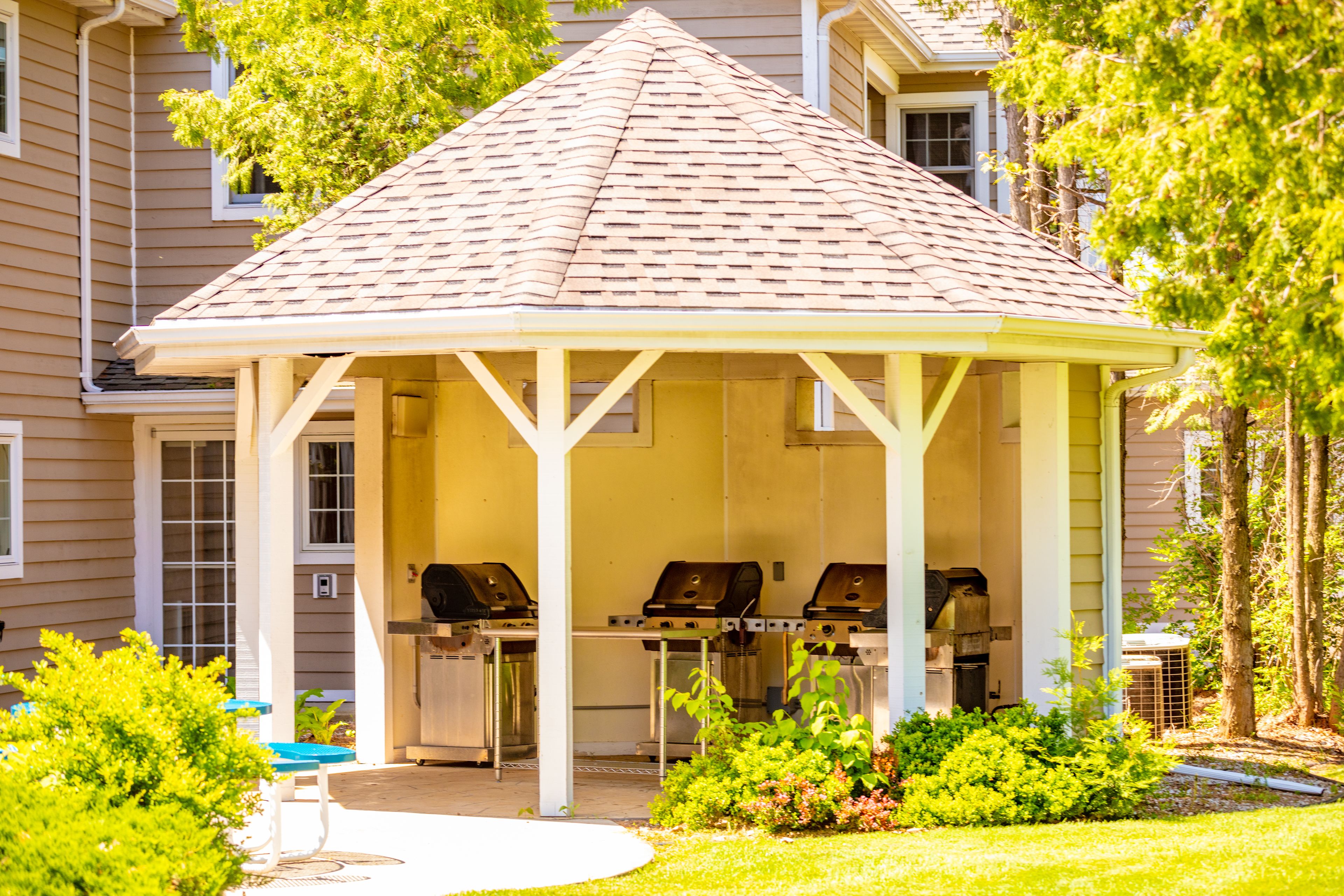 A covered outdoor area with barbecue grills.