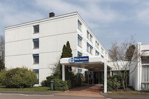 Een hotelgebouw met een bord waarop 'Best Western Hotel Achim Bremen' staat.