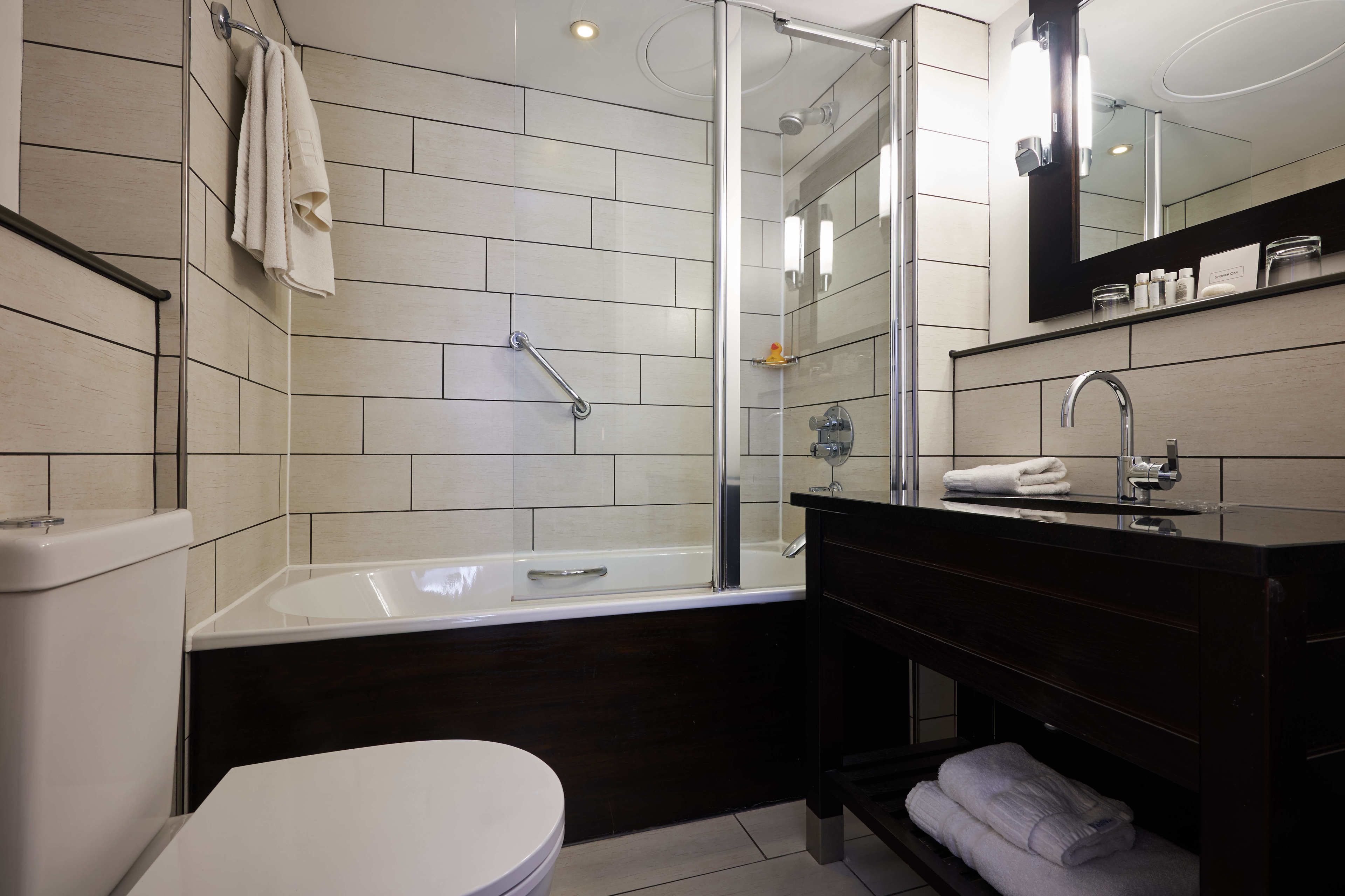 designer toiletries, hair dryer, towels