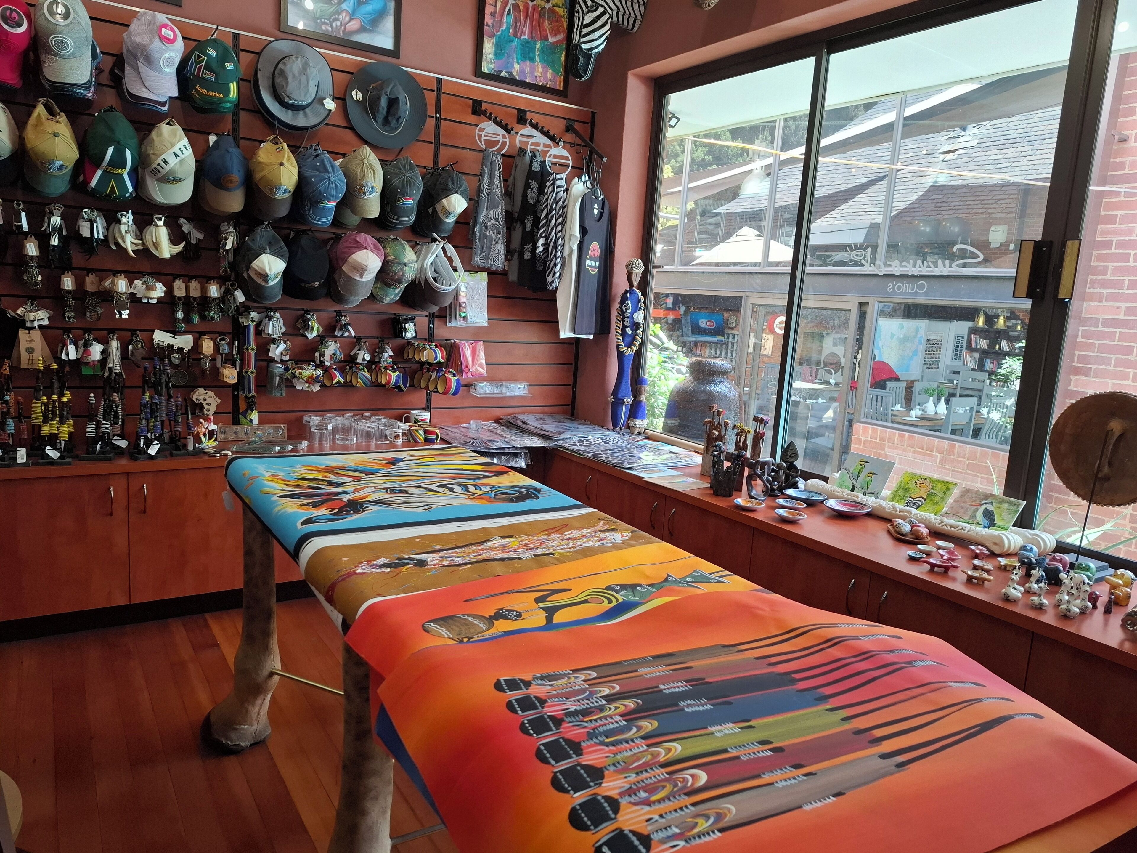 A shop with a variety of hats and accessories displayed on shelves and walls.