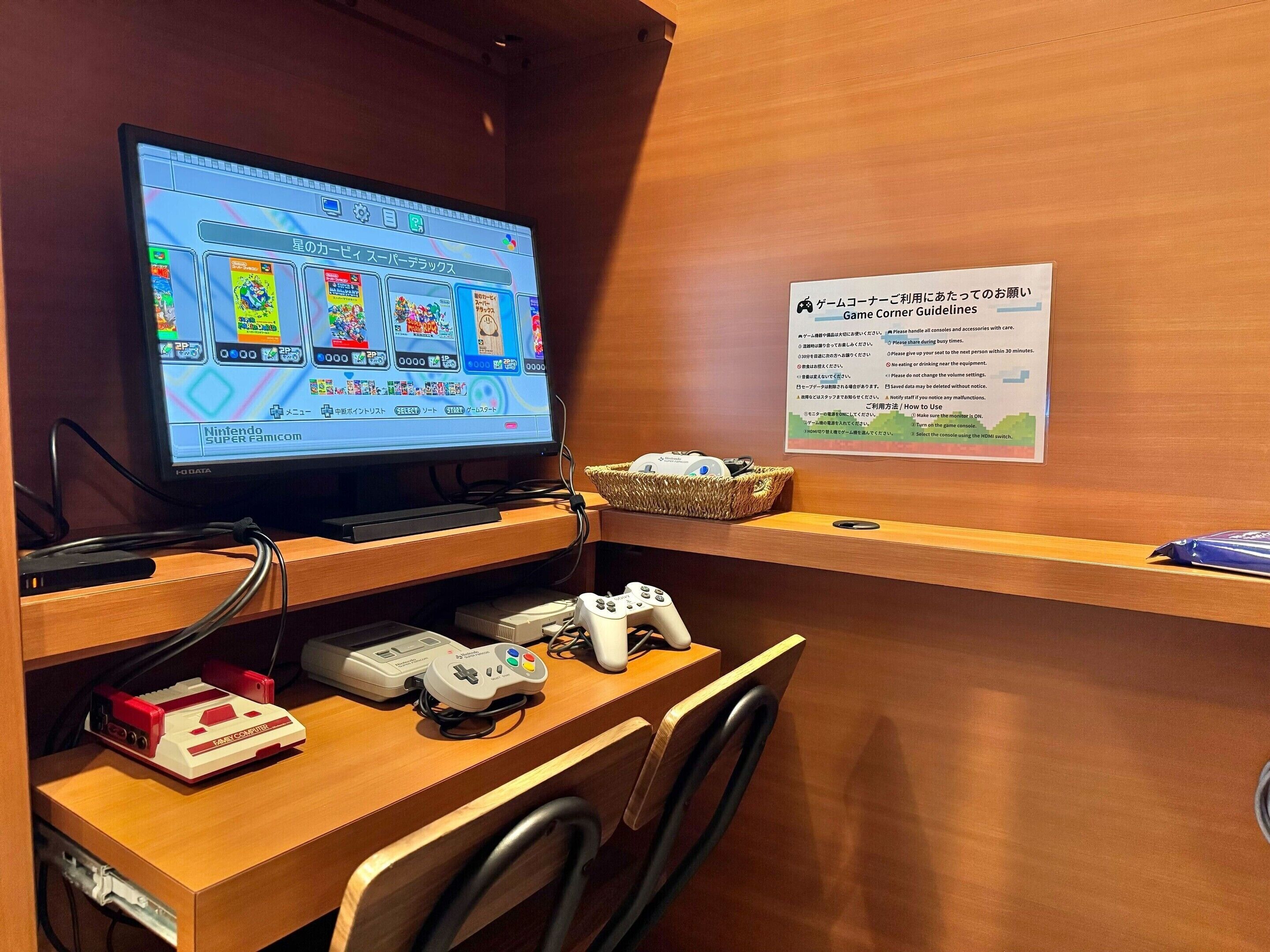 A gaming station with a Nintendo Super Famicom, a Game Boy, and a GameCube controller.