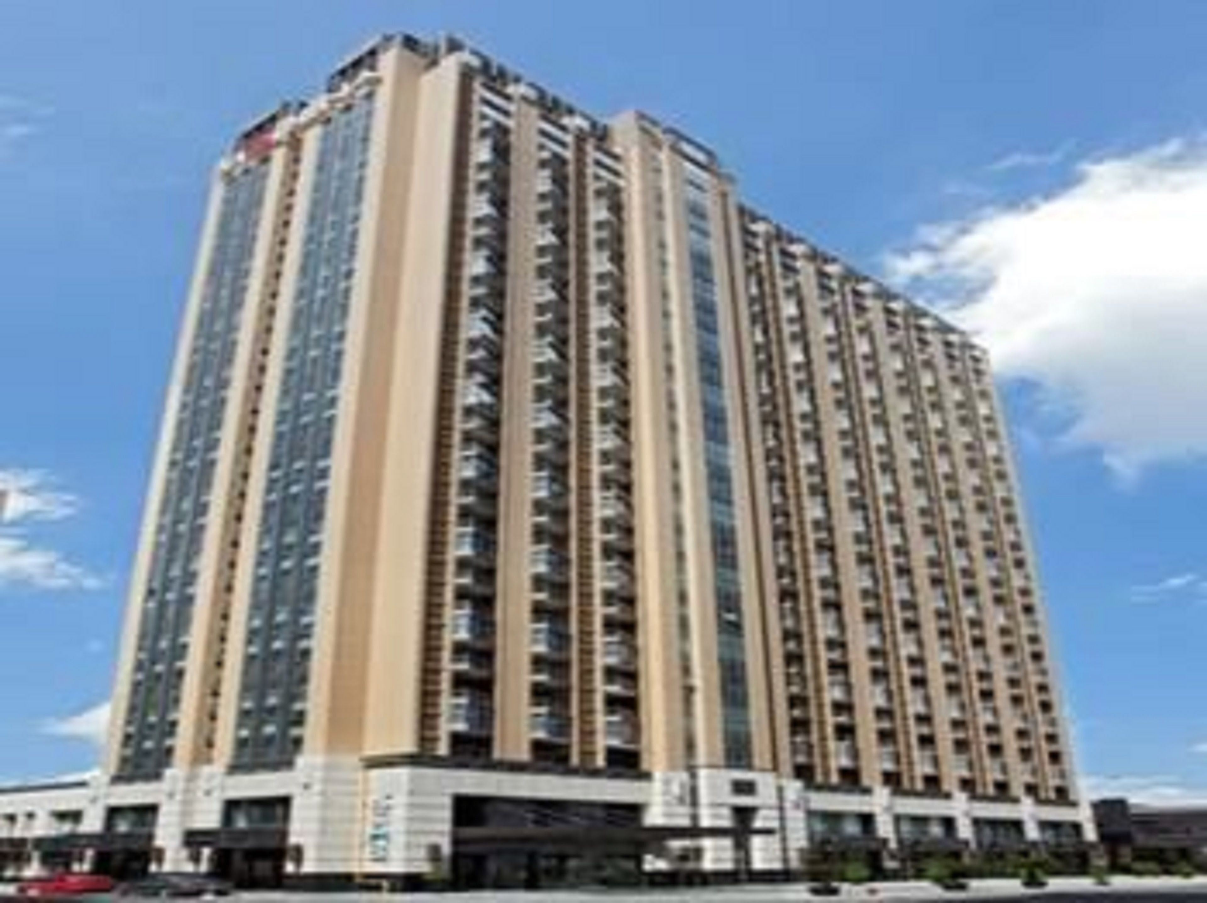 A high-rise residential building with multiple floors, balconies, and a modern architectural design.