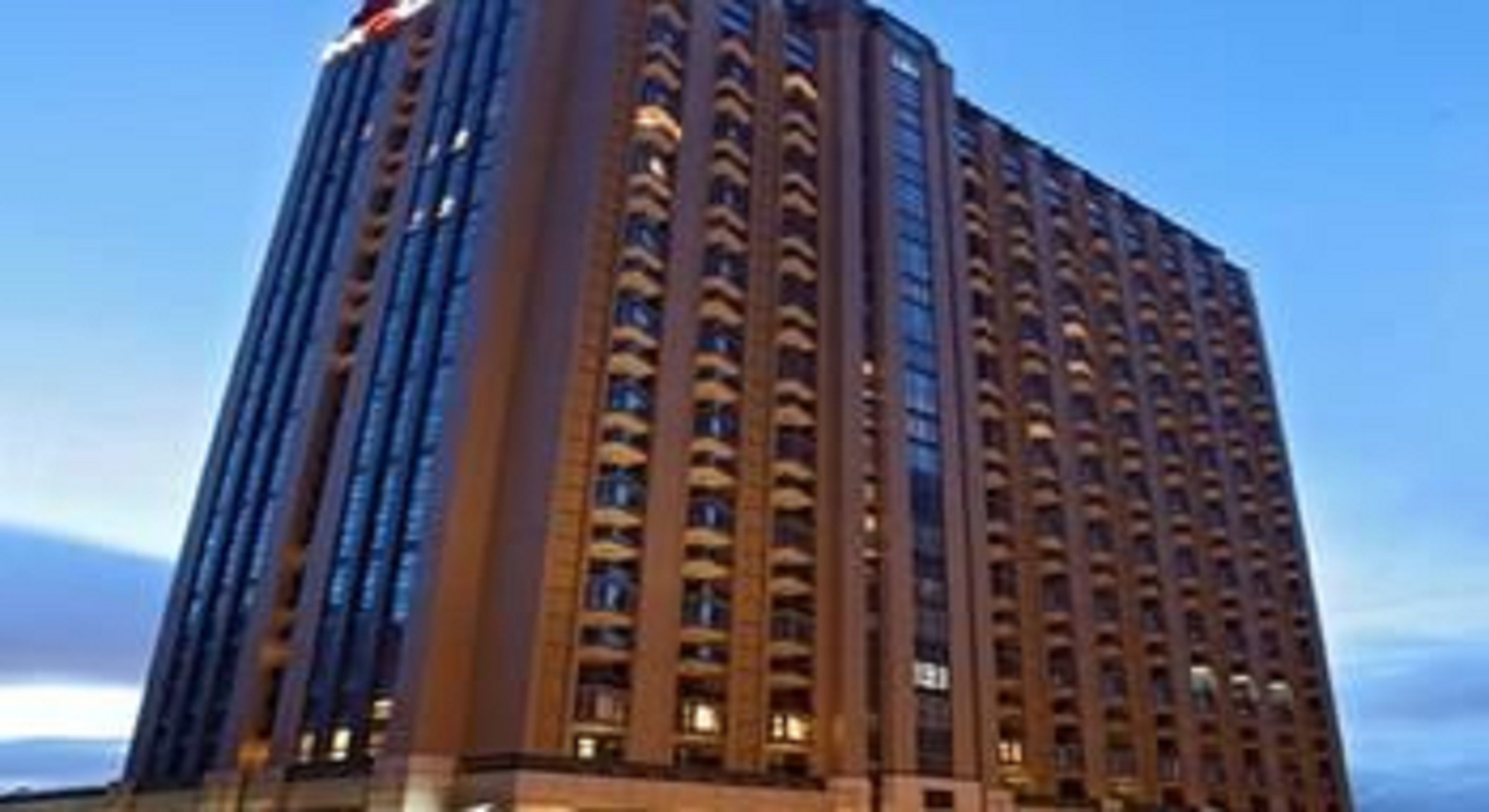 A tall, rectangular hotel building with multiple floors and a consistent window pattern.