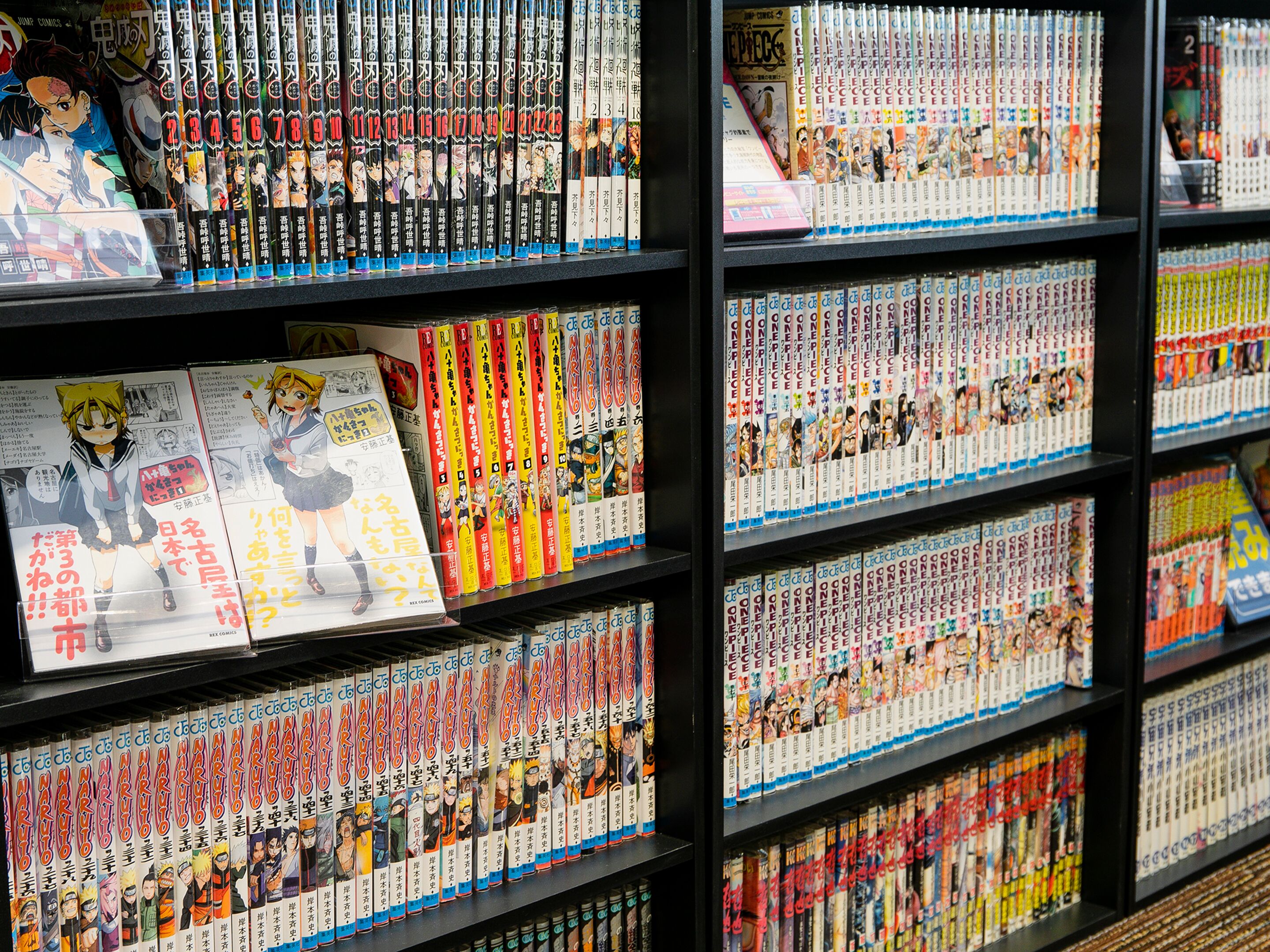 A bookstore with manga volumes arranged on shelves.