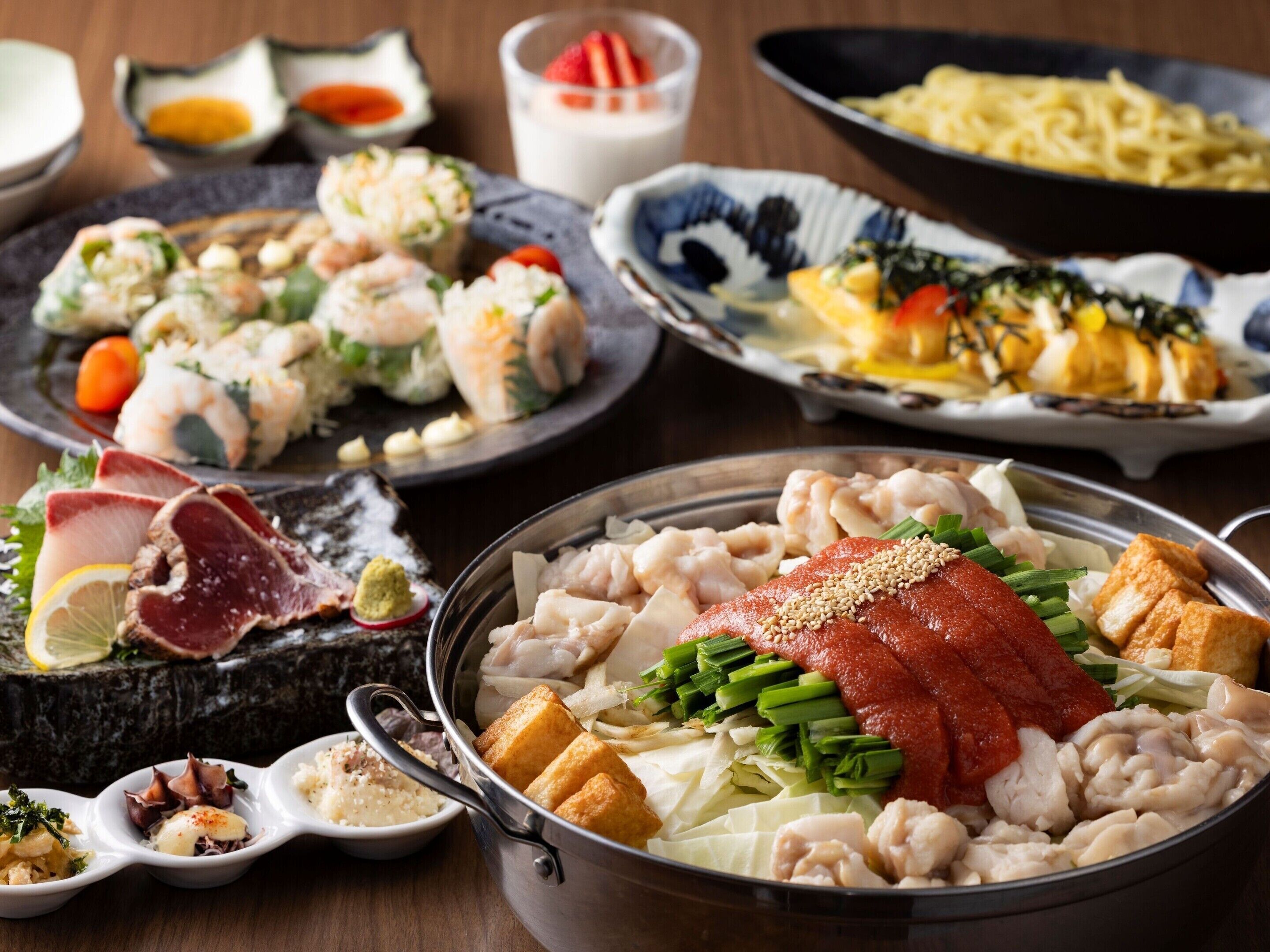A variety of dishes including sushi, sashimi, and a bowl of seafood with tofu.