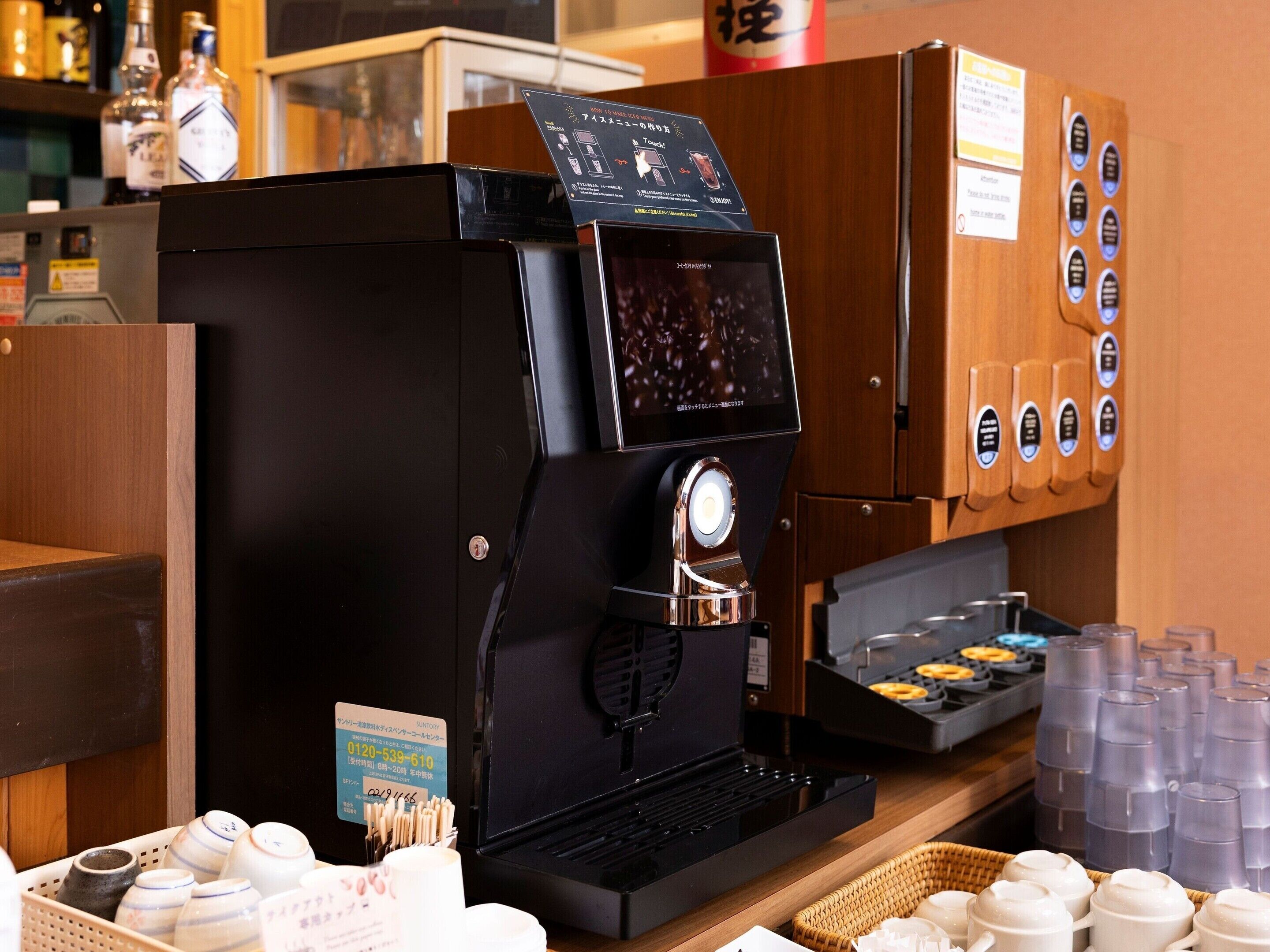 A coffee machine with a digital display, a coffee grinder, and a selection of coffee pods.
