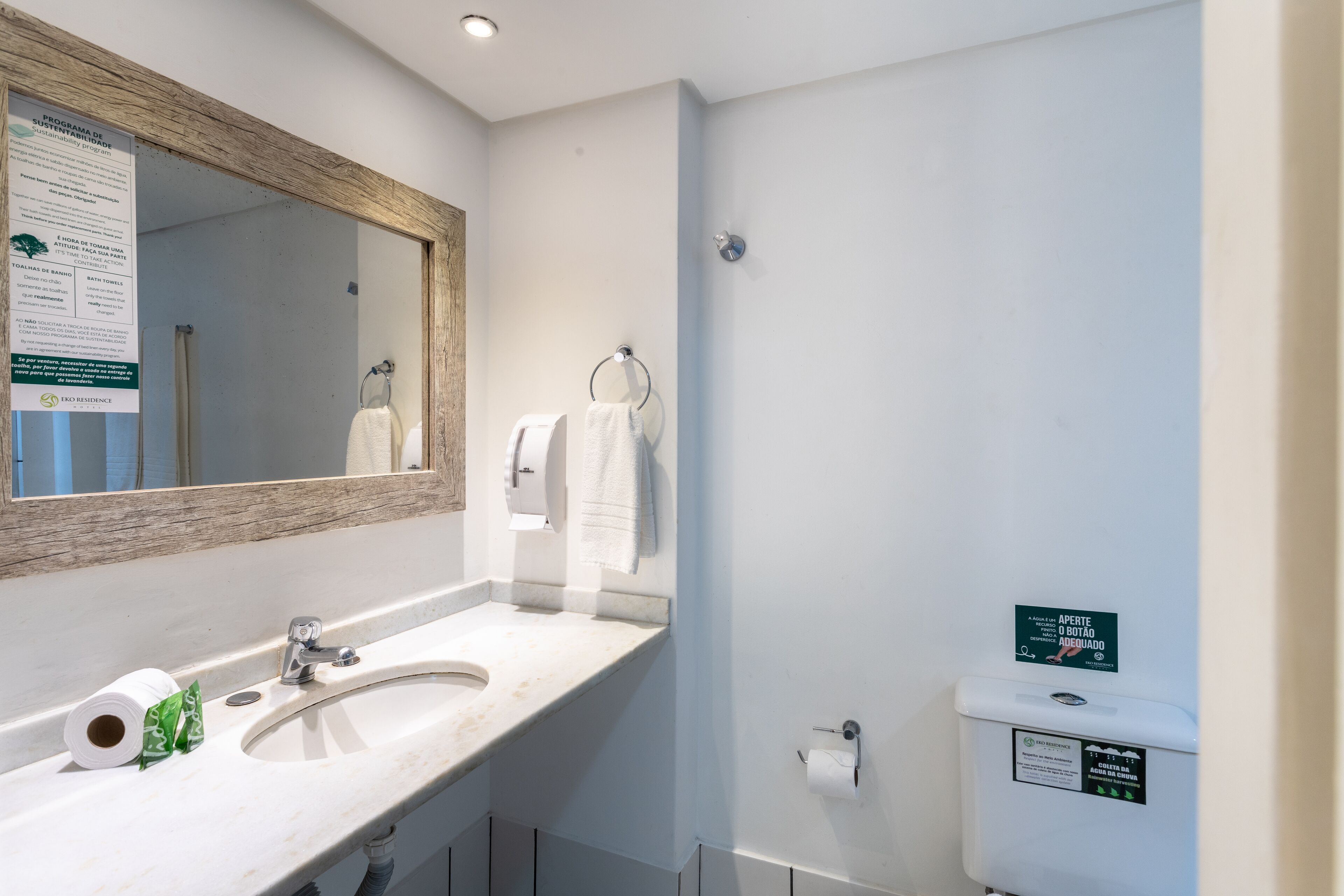 A bathroom with a sink, mirror, towel rack, and toilet.