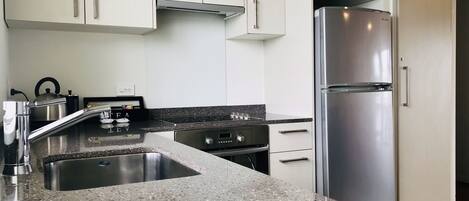 Deluxe Apartment, 2 Bedrooms, Non Smoking, Jetted Tub | Private kitchen | Mini-fridge, microwave, electric kettle, toaster