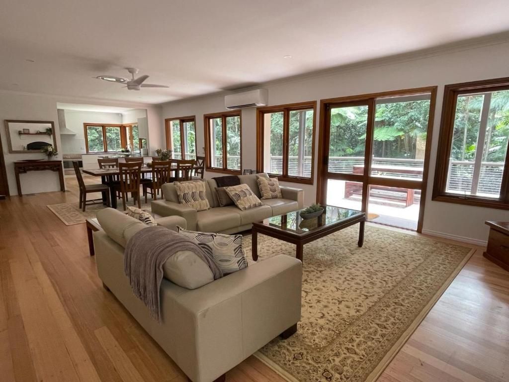 A spacious living room with a sofa, coffee table, and dining area.