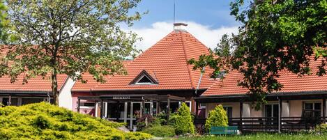 A building with a red roof and a sign that reads "RESTAURANT".