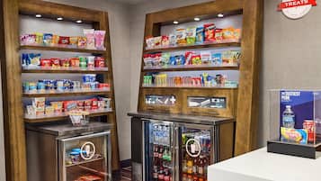 A snack and beverage display area with shelves stocked with various snacks and drinks.