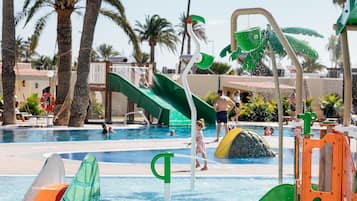 Children can play and splash in the adjacent water play area, featuring a slide and interactive water feature.