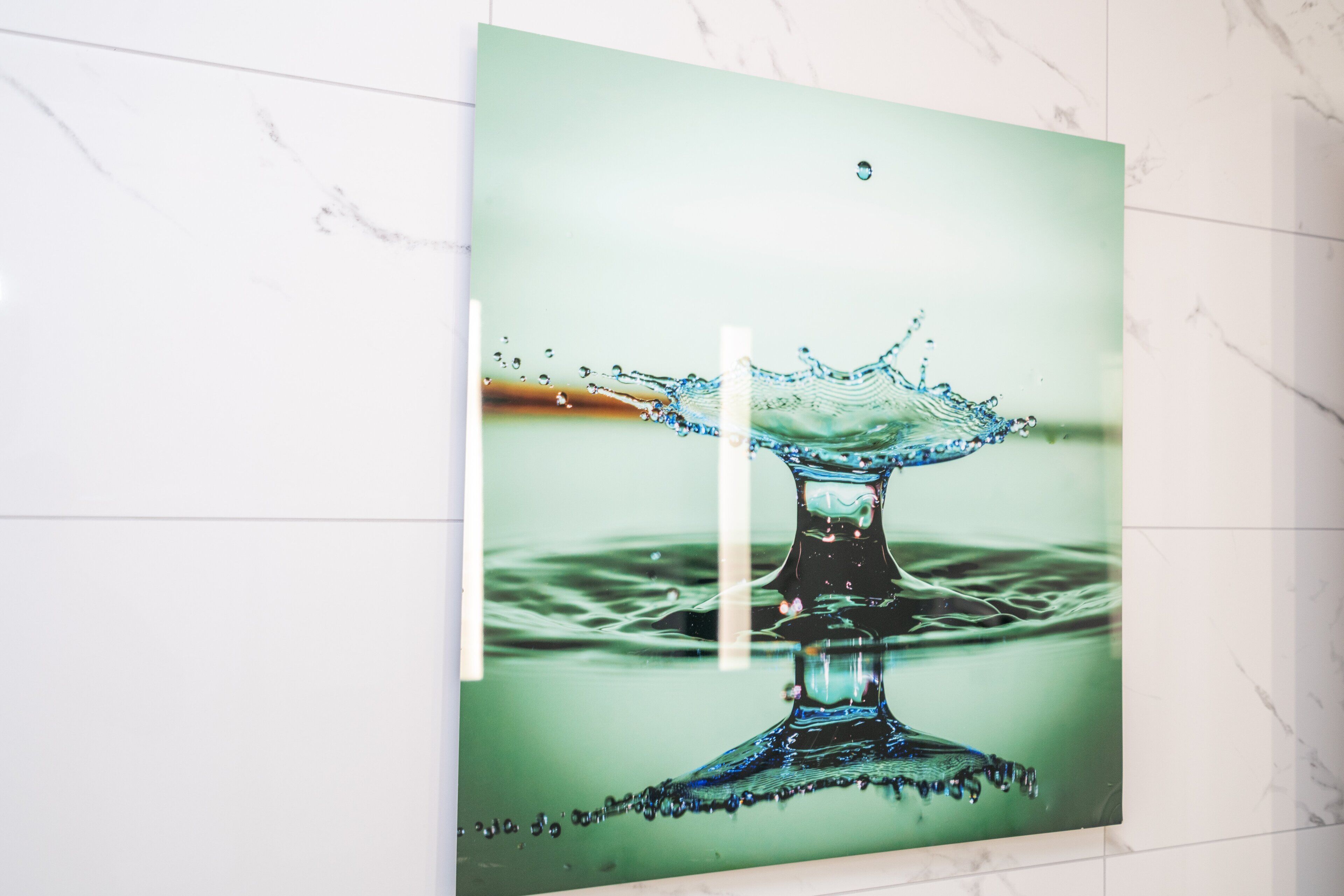 A photograph of a water splash on a green background.