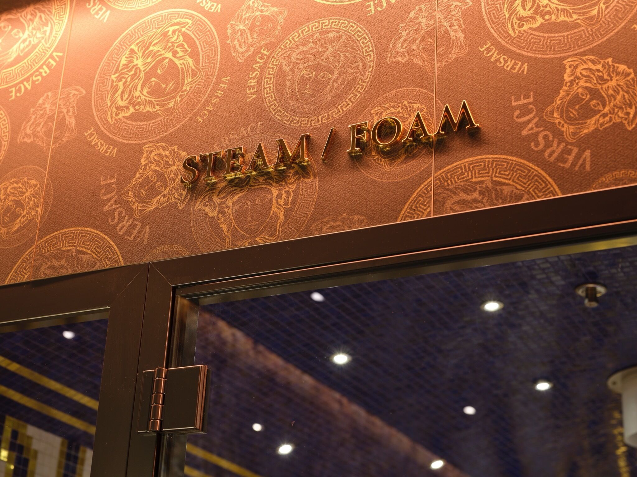 A storefront with the text "STEAM FOAM" and a decorative pattern.