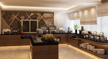 A modern hotel lobby with a reception desk, buffet area, and decorative elements like plants and lighting fixtures.