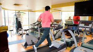 A gym with treadmills, weight machines, and a large mirror. - Dammam Palace Hotel (Dammam)