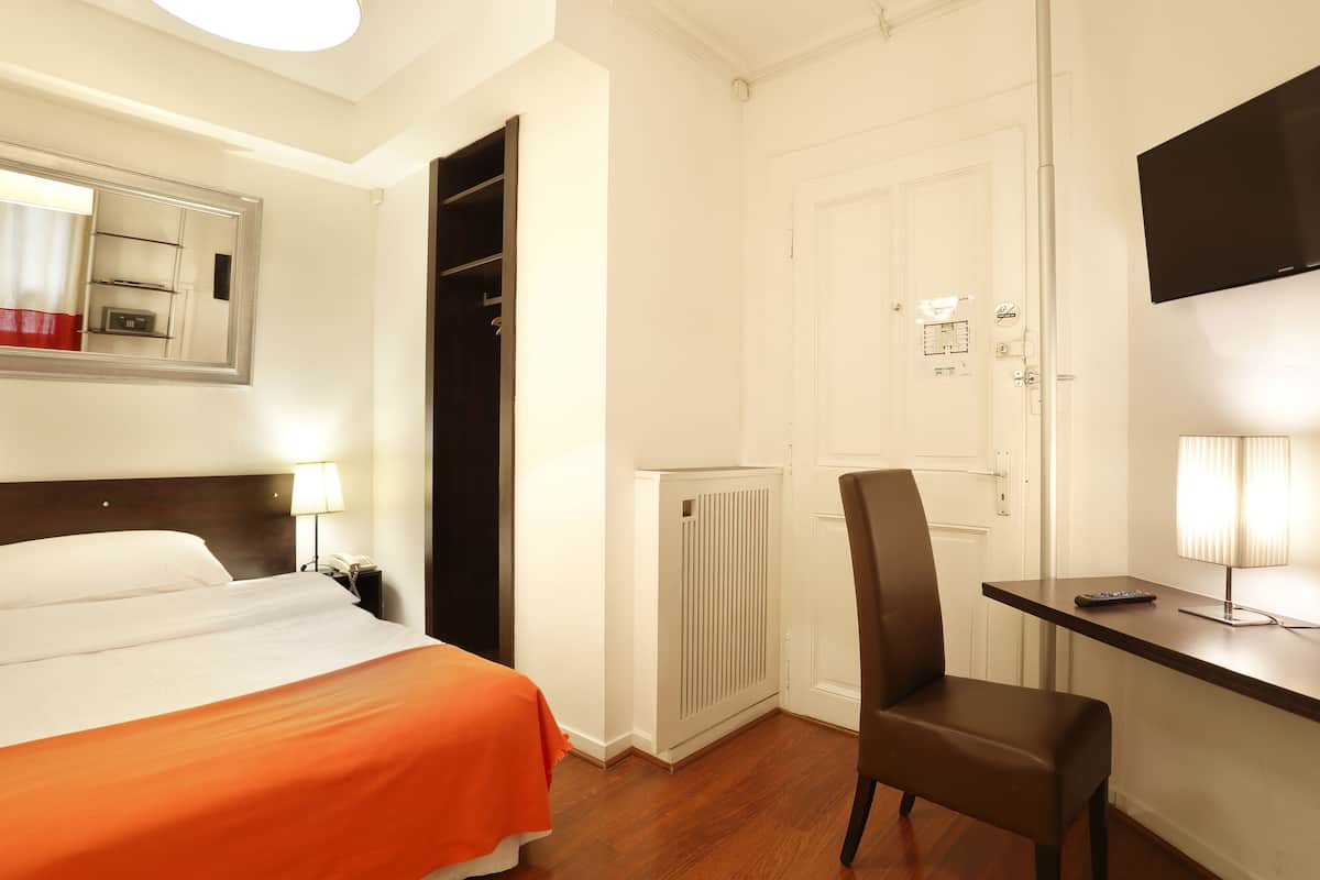 أغطية فراش متميزة وخزنة داخل الغرفة ومكتب وستائر تعتيم