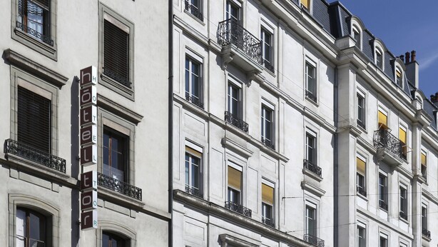 A multi-story hotel with a classic architectural style, featuring balconies and large windows. - Torhôtel Genève (Geneva)
