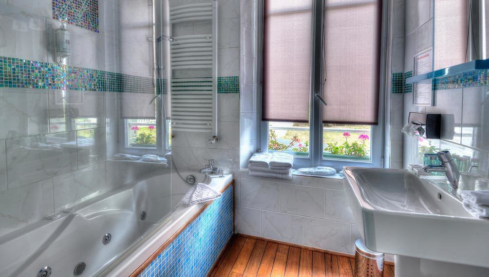 bathtub, jetted bath, designer toiletries, hair dryer