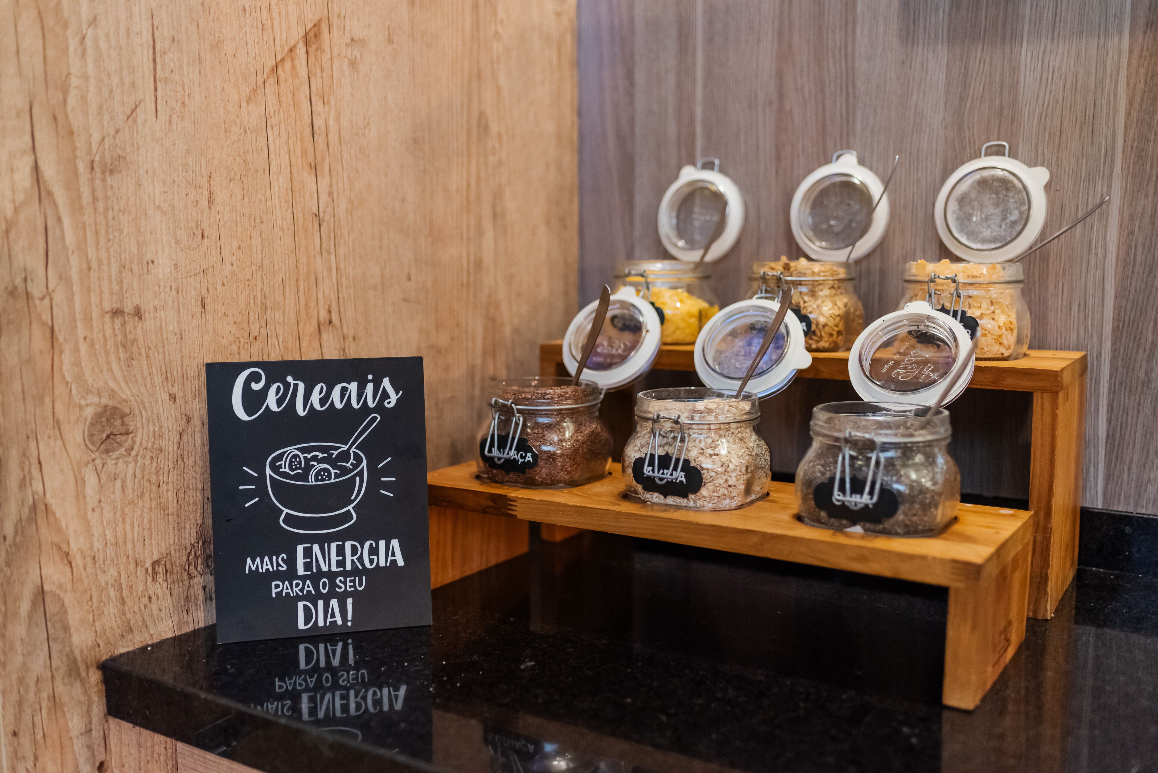 A breakfast display with cereal jars and a sign promoting energy for the day.