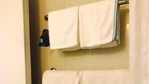 A bathroom with two white towels hanging on a towel rack, one with a logo and the other plain. - Jinjiang Inn Beijing Olympic Village Datun Road (Beijing)