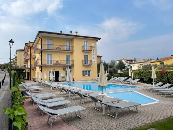 Seasonal outdoor pool, open 8:00 AM to 8:00 PM, pool umbrellas