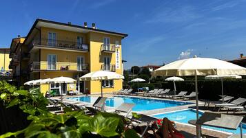 Seasonal outdoor pool, open 8:00 AM to 8:00 PM, pool umbrellas