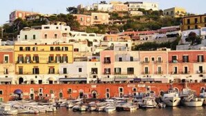 A coastal town with colorful buildings and a marina filled with boats.