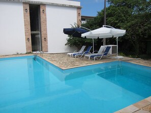 Outdoor pool, open 9:00 AM to 9:00 PM, pool umbrellas, pool loungers