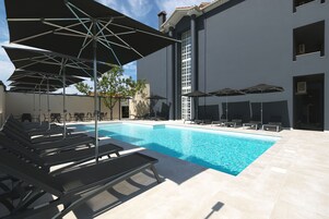 Outdoor pool, open 9:00 AM to 8:00 PM, pool umbrellas, sun loungers