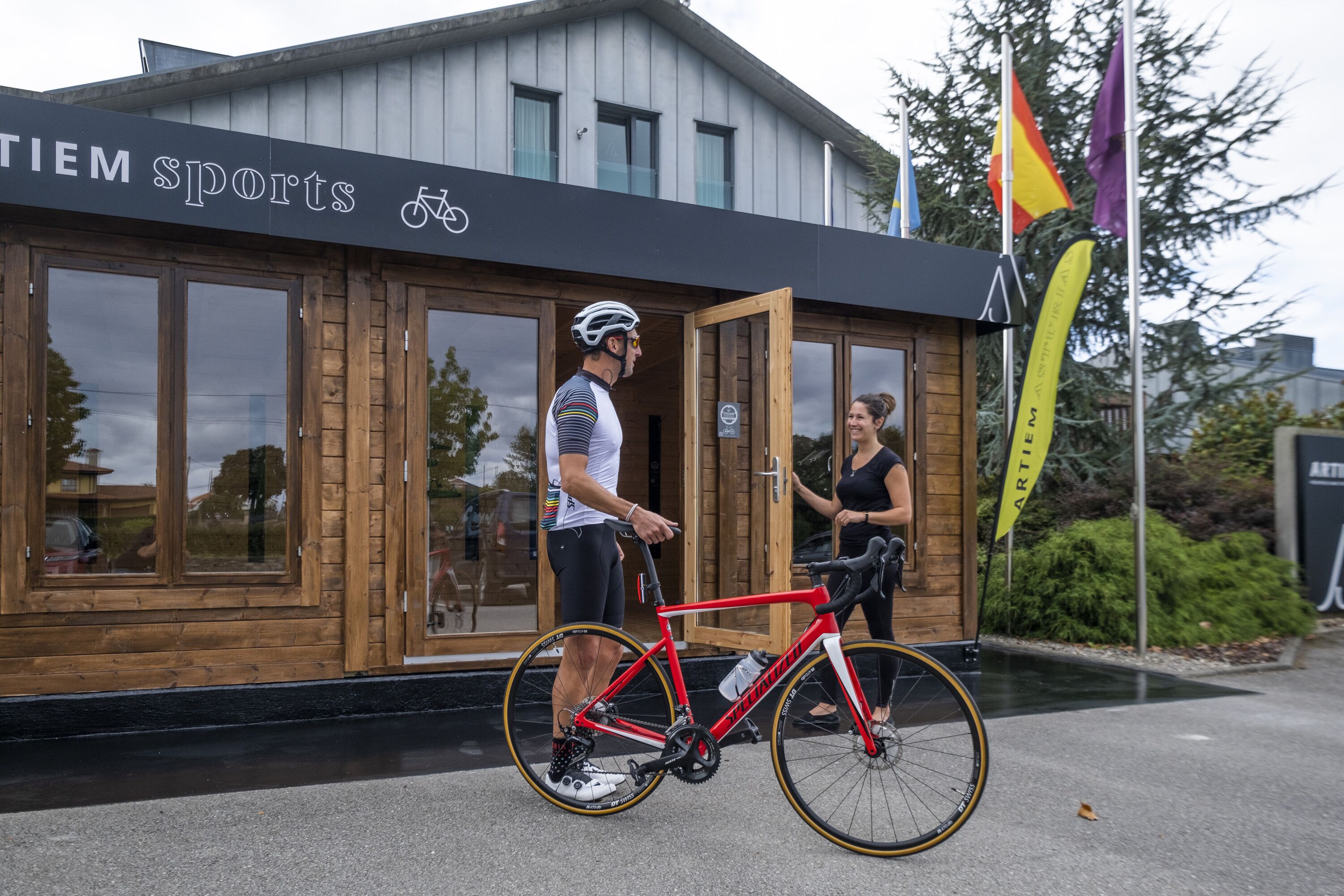 A building with a sign reading "TIEM Sports" and a bicycle.