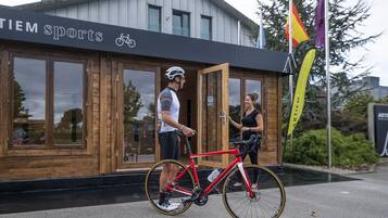A building with a sign reading "TIEM Sports" and a bicycle.