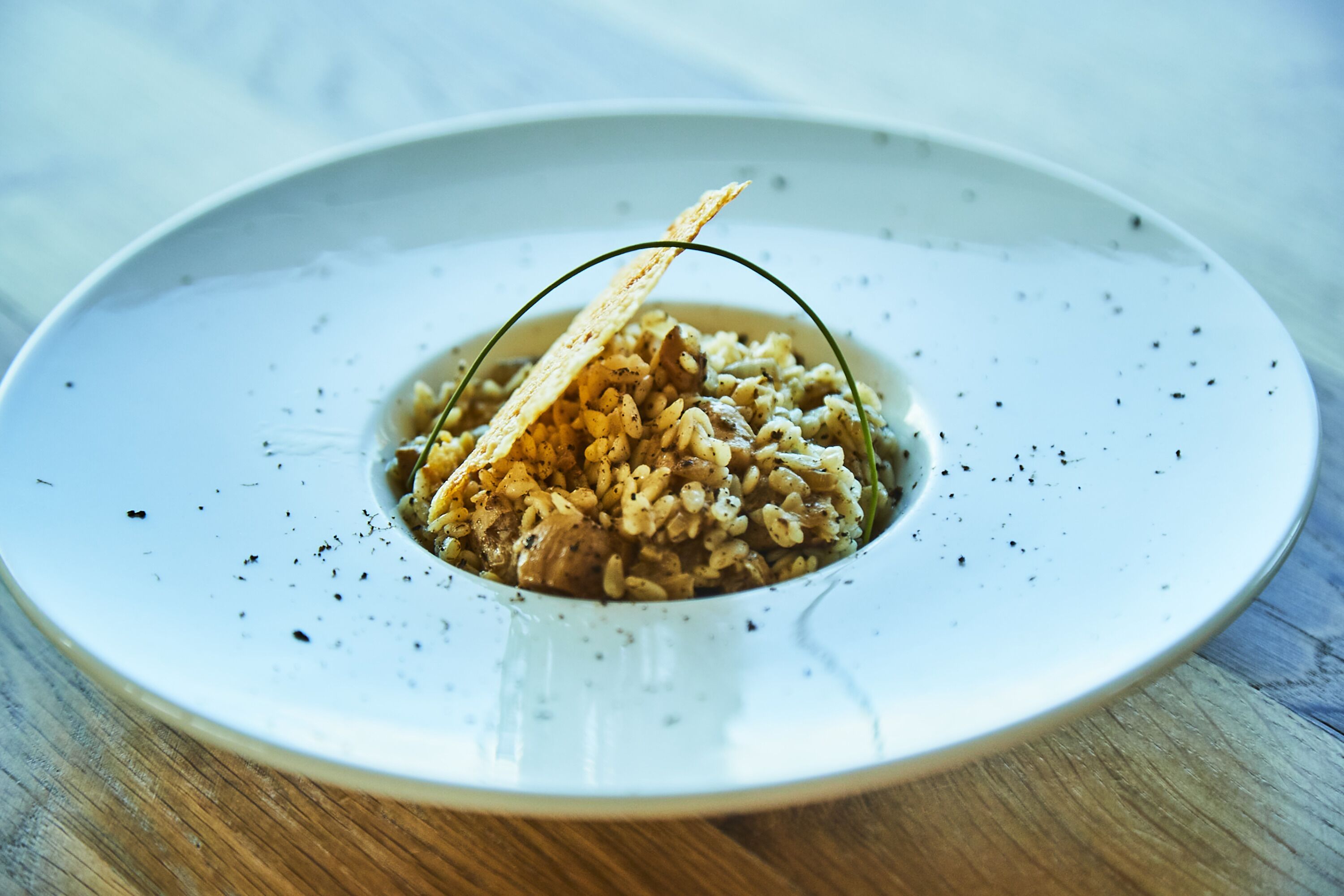 A plate of food with a piece of bread on top, served on a white plate.
