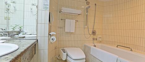 A bathroom with a toilet, sink, and bathtub.