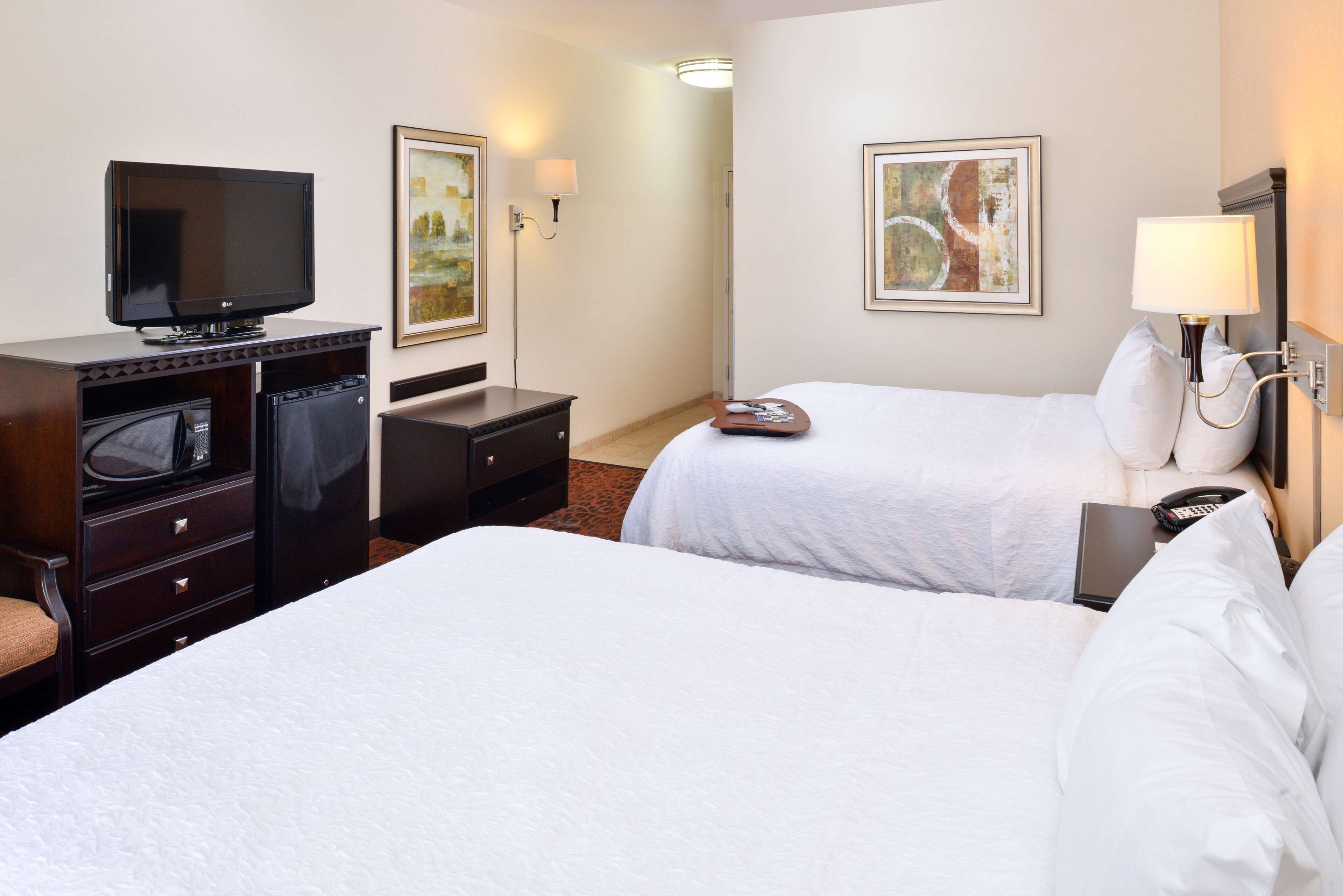 room, 2 queen beds | in-room safe, iron/ironing board, free cots/infant beds