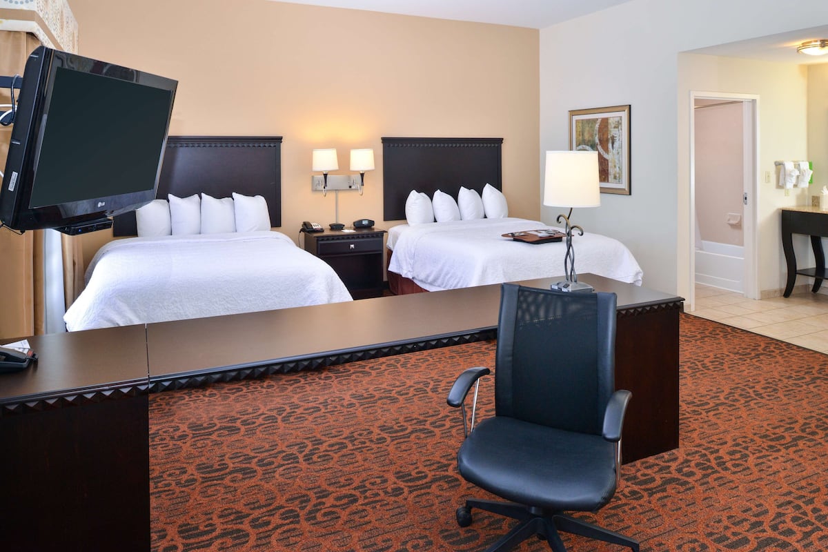 suite, 2 queen beds, non smoking | in-room safe, iron/ironing board, free cots/infant beds