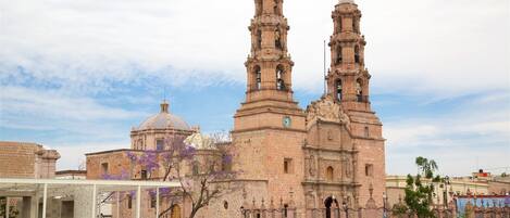 A historic cathedral with two prominent towers and a dome.