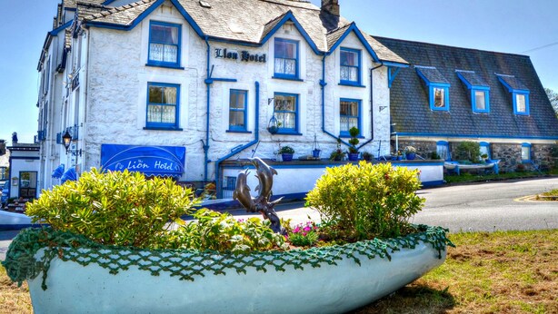 A two-story building with a sign reading "Lion Hotel".