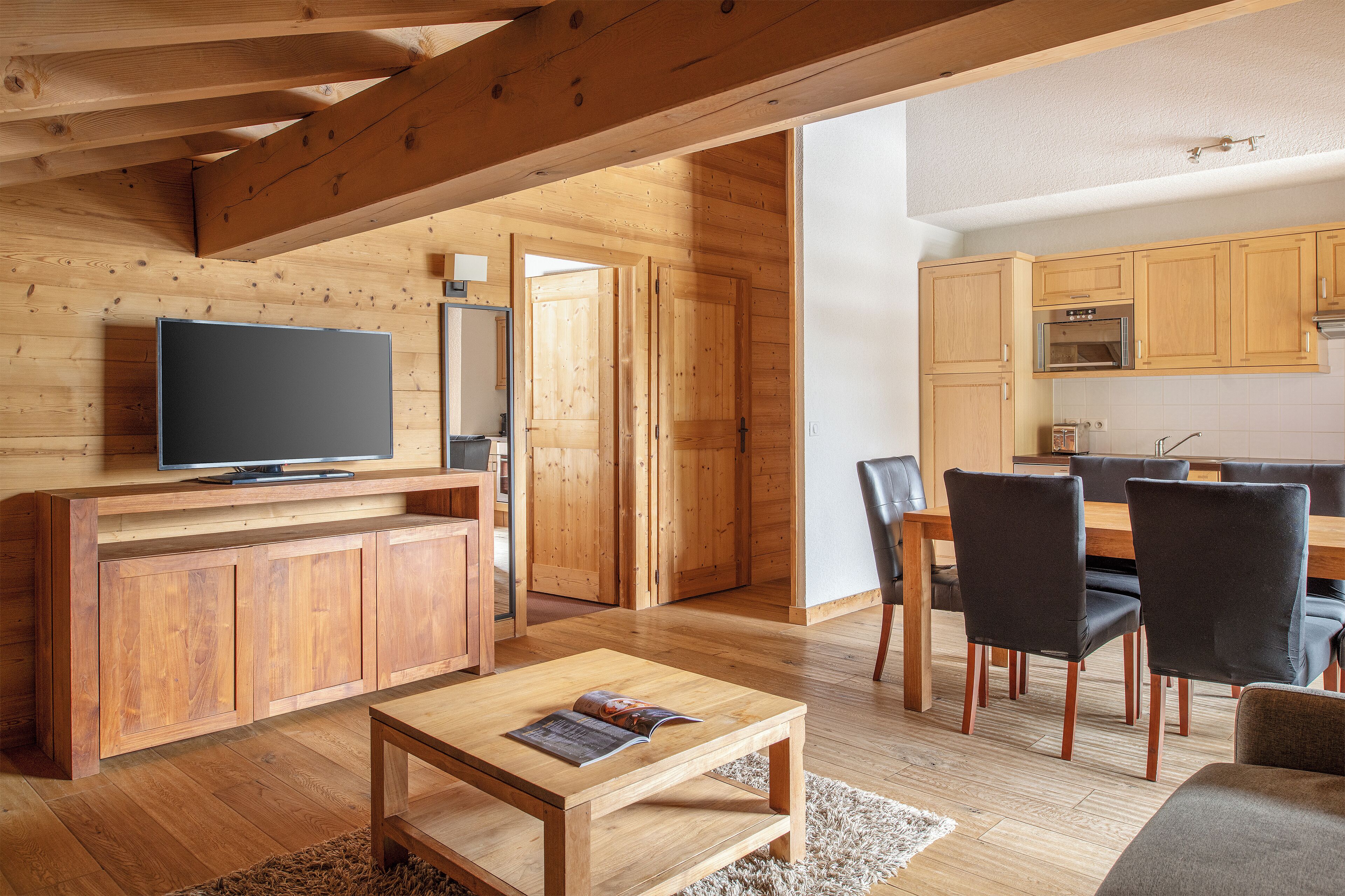 A modern kitchen with wooden cabinets and a built-in oven.
